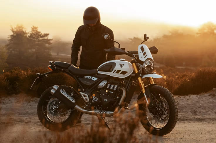 It also gets a high fender and body coloured flyscreen as standard. Triumph Scrambler 400 XC white colour right side profile static in field